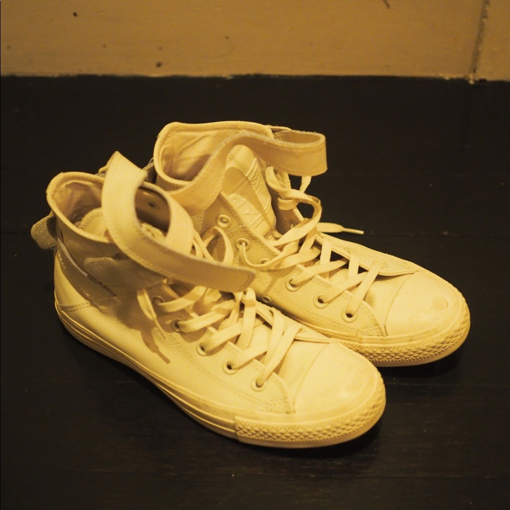 White, leather high-top converse.